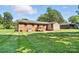 View of the house from the backyard with a manicured lawn and wooden deck at 2705 Lowell Bethesda Rd, Gastonia, NC 28056