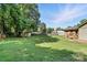 Spacious backyard with a shed, wooden fence, and ample green space for outdoor activities at 2705 Lowell Bethesda Rd, Gastonia, NC 28056