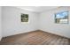 Roomy bedroom with light wood floors and natural lighting through two windows at 2705 Lowell Bethesda Rd, Gastonia, NC 28056