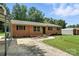 Brick ranch-style house featuring a driveway, carport, and landscaped yard at 2705 Lowell Bethesda Rd, Gastonia, NC 28056