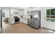 Contemporary kitchen featuring white cabinets, stainless steel appliances, and bright natural light at 2705 Lowell Bethesda Rd, Gastonia, NC 28056