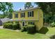 Inviting yellow home featuring black shutters, a well-manicured lawn, and a cozy front entrance at 2825 Edwin Jones Dr, Charlotte, NC 28269