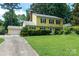 Charming two-story yellow home with a well-maintained front yard and classic black shutters at 2825 Edwin Jones Dr, Charlotte, NC 28269