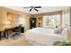 Comfortable bedroom with a large window, ceiling fan, and a dedicated workspace at 3109 Buckleigh Dr, Charlotte, NC 28215