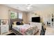 Bedroom featuring a ceiling fan, a window, and a dresser with a TV at 3109 Buckleigh Dr, Charlotte, NC 28215