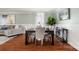 Elegant dining room with wood floors, modern chandelier, and seating for six at 3109 Buckleigh Dr, Charlotte, NC 28215