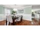 Bright dining room with hardwood floors, modern chandelier and seating for six at 3109 Buckleigh Dr, Charlotte, NC 28215