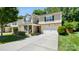 Beautiful two-story home with stone accents, a two-car garage, green shutters, and landscaped front yard at 3109 Buckleigh Dr, Charlotte, NC 28215