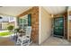 Cozy front porch featuring rocking chairs, a table, and a view of the stone exterior at 3109 Buckleigh Dr, Charlotte, NC 28215