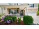Charming front porch with stone facade, green shutters, rocking chairs, and beautifully landscaped garden at 3109 Buckleigh Dr, Charlotte, NC 28215