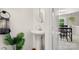 Clean and simple half-bath featuring a pedestal sink and a decorative mirror at 3109 Buckleigh Dr, Charlotte, NC 28215