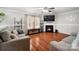 Cozy living room with hardwood floors, fireplace, and plenty of natural light at 3109 Buckleigh Dr, Charlotte, NC 28215
