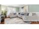 Bright living room featuring a large sectional sofa, an accent rug, and a decorative painting at 3109 Buckleigh Dr, Charlotte, NC 28215