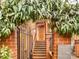 Inviting brick entryway featuring a charming garden, stairs, and wrought iron gate at 311 Settlers Ln, Charlotte, NC 28202