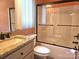 Bathroom featuring granite vanity and shower tub combo at 323 Wendover Dr, Locust, NC 28097