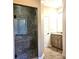 Bathroom featuring a walk-in shower with glass door and double sink vanity at 323 Wendover Dr, Locust, NC 28097