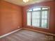 Bedroom featuring neutral carpet and large window letting in plenty of light at 323 Wendover Dr, Locust, NC 28097