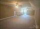 Large bonus room with neutral carpet and multiple ceiling fans at 323 Wendover Dr, Locust, NC 28097
