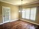 Light-filled dining room with wood floors and a modern chandelier at 323 Wendover Dr, Locust, NC 28097