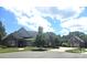 Lovely brick home with detached garage, lush landscaping, and a serene suburban view at 323 Wendover Dr, Locust, NC 28097
