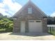 Charming two-car detached garage constructed with brick and an additional side entrance door at 323 Wendover Dr, Locust, NC 28097