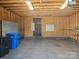 Inside the two-car garage with space for storage and work bench at 323 Wendover Dr, Locust, NC 28097