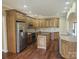 Spacious kitchen with stainless steel appliances, island, granite countertops, and custom wood cabinets at 323 Wendover Dr, Locust, NC 28097
