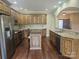 Large kitchen featuring stainless steel appliances, granite countertops, an island, and wood floors at 323 Wendover Dr, Locust, NC 28097