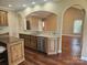 Kitchen featuring granite counters, wooden cabinets and island, and stainless steel dishwasher at 323 Wendover Dr, Locust, NC 28097