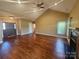 Bright and open living room with high ceilings, hardwood floors, and a cozy fireplace at 323 Wendover Dr, Locust, NC 28097