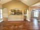 Spacious living area with hardwood floors, seamlessly connected to the kitchen with a modern design at 323 Wendover Dr, Locust, NC 28097