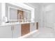 Bright bathroom featuring a double vanity, decorative mirrors and marble floors at 3394 Governors Island Dr, Denver, NC 28037