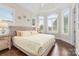 Light-filled bedroom with tray ceiling, hardwood floors and shuttered windows at 3394 Governors Island Dr, Denver, NC 28037