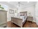 This bedroom features hardwood floors, a ceiling fan and neutral paint at 3394 Governors Island Dr, Denver, NC 28037