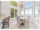 Bright dining area featuring a chandelier and large windows with lake views at 3394 Governors Island Dr, Denver, NC 28037