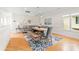 Dining room with a rustic table, a blue accent rug and modern lighting at 3394 Governors Island Dr, Denver, NC 28037