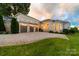 Grand brick home with a spacious driveway and well-kept lawn, creating a welcoming and luxurious entrance at 3394 Governors Island Dr, Denver, NC 28037
