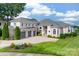 Expansive home featuring manicured landscaping, multi-car garage, and a paved driveway at 3394 Governors Island Dr, Denver, NC 28037