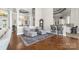 Open-concept living room features elegant columns, hardwood floors, and a view into the kitchen at 3394 Governors Island Dr, Denver, NC 28037