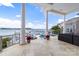 Covered patio featuring a swimming pool, lounge chairs, and stunning waterfront views at 3394 Governors Island Dr, Denver, NC 28037
