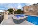 Backyard featuring a pool and hot tub with stone accents, providing a luxurious outdoor experience at 3394 Governors Island Dr, Denver, NC 28037