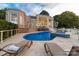 A luxurious backyard with a pool, hot tub, and lounge chairs, perfect for relaxing and entertaining outdoors at 3394 Governors Island Dr, Denver, NC 28037