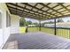 Inviting back deck featuring a dark wood floor, a covered area, and a view of the spacious backyard and scenery at 3624 Ramsey Rd, Sharon, SC 29742