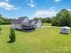Aerial view of a large backyard featuring a covered deck, shed, and plenty of green space, perfect for recreation at 3624 Ramsey Rd, Sharon, SC 29742