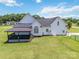 Exterior of home with covered deck overlooking large backyard, generator, and fencing at 3624 Ramsey Rd, Sharon, SC 29742