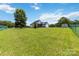Wide shot of a large, fenced backyard with a well-maintained lawn, shed, and covered patio, offering ample space at 3624 Ramsey Rd, Sharon, SC 29742