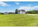 Spacious backyard with lush green grass, a fenced-in area, and a well-maintained home in the background at 3624 Ramsey Rd, Sharon, SC 29742