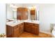 Bathroom with double sink vanity, white countertops and oak cabinetry at 3624 Ramsey Rd, Sharon, SC 29742