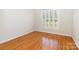 This bedroom features hardwood floors and natural light from the shuttered window at 3624 Ramsey Rd, Sharon, SC 29742