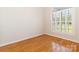 Bright bedroom with hardwood floors and a large window with shuttered blinds at 3624 Ramsey Rd, Sharon, SC 29742